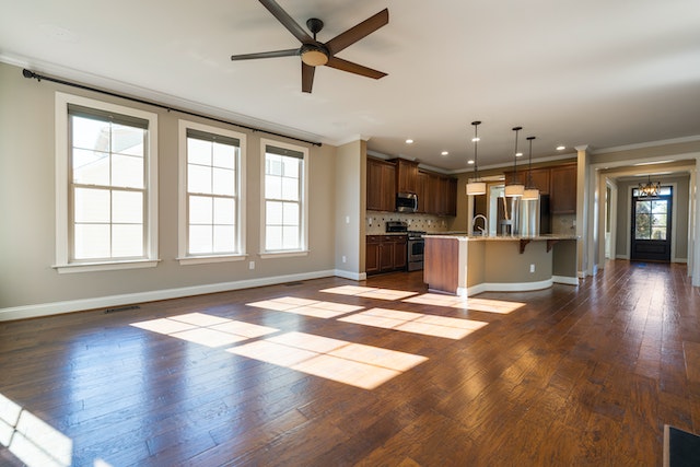 unfurnished main floor with an open concept layout and three large windows